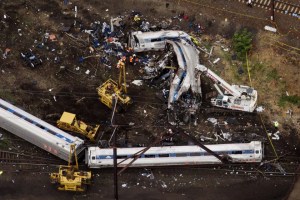 Emergency workers look through the remains of a derailed Amtrak train in Philadelphia, Pennsylvania May 13, 2015.  Rescue workers on Wednesday sifted through twisted metal and debris from the wreck of the Amtrak train that derailed in Philadelphia, killing six people and injuring scores of others, as investigators began reviewing data to determine the cause of an accident. REUTERS/Lucas Jackson       TPX IMAGES OF THE DAY